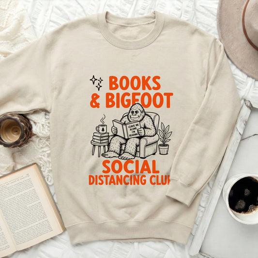 Bigfoot reading a book saying "Leave me alone, I'm reading" with text "Books & Bigfoot Social Distancing Club".