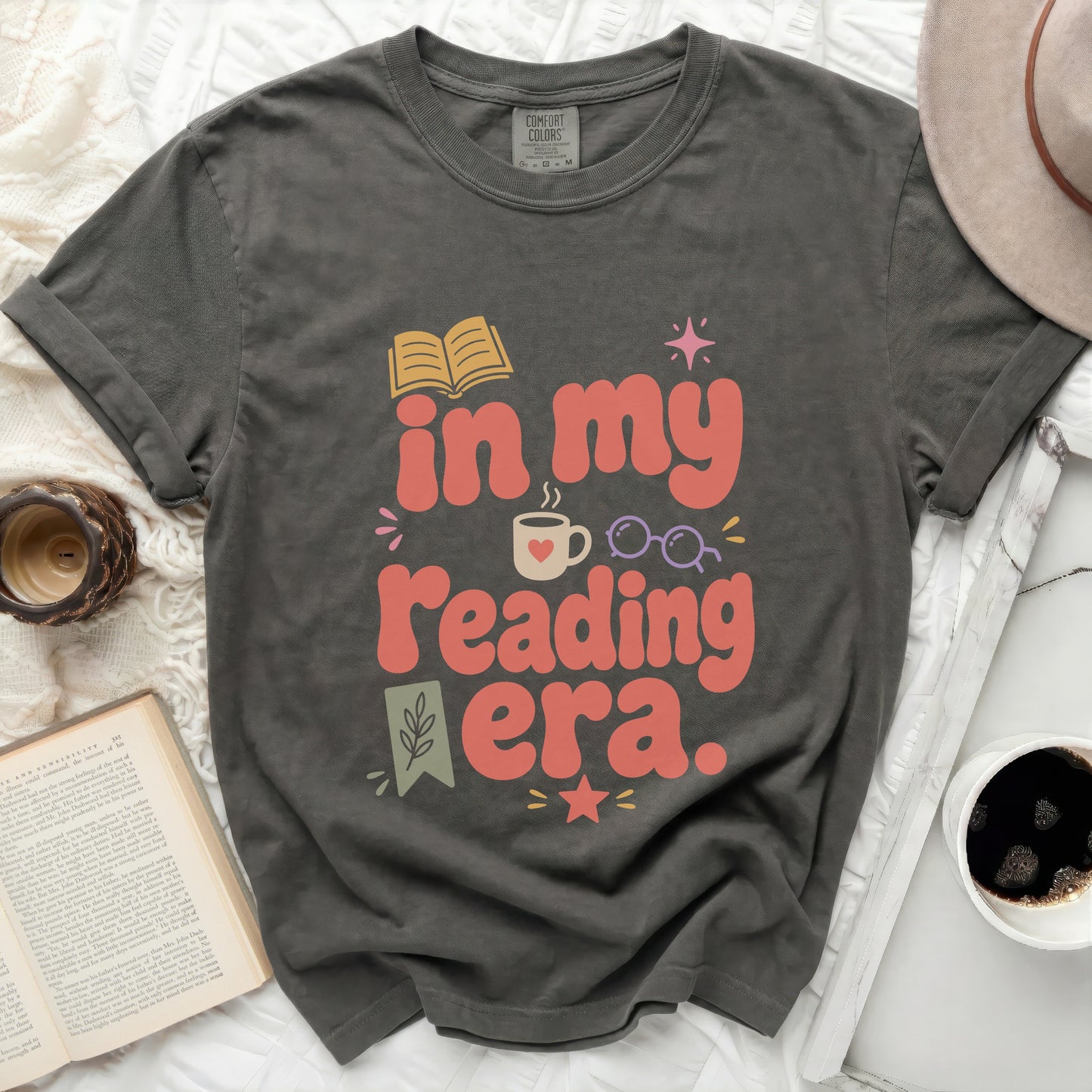 Graphic tee with "in my reading era." text and book graphic.