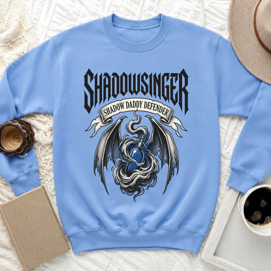 Light blue sweatshirt with "Shadowsinger Shadow Daddy Defender" text and dragon wings design.