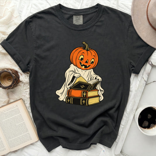 Dark gray t-shirt with a vintage-style pumpkin ghost reading books graphic.