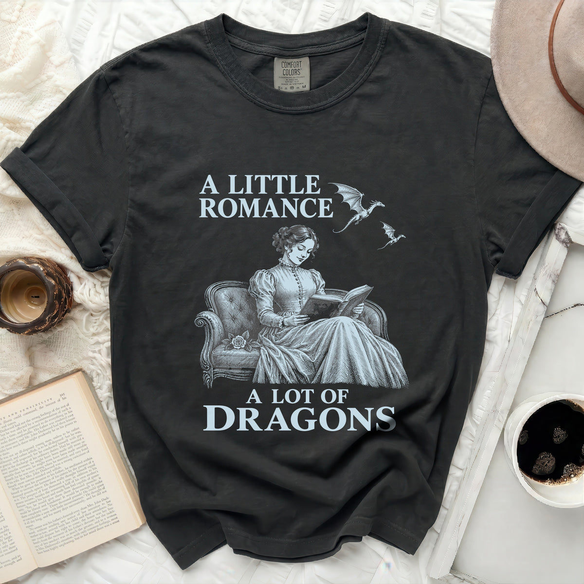 A Little Romance A Lot of Dragons t-shirt with dragons and a woman reading.