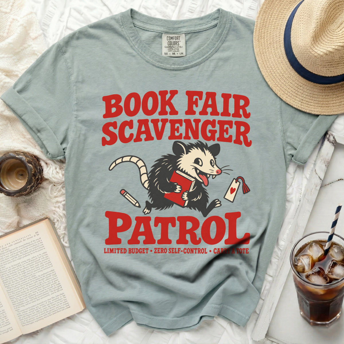 Gray t-shirt with "Book Fair Scavenger Patrol" design featuring an opossum.