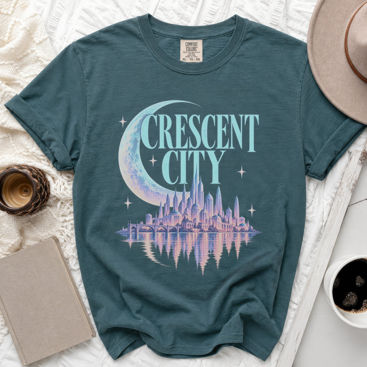 Teal t-shirt with "Crescent City" text and a city skyline graphic.