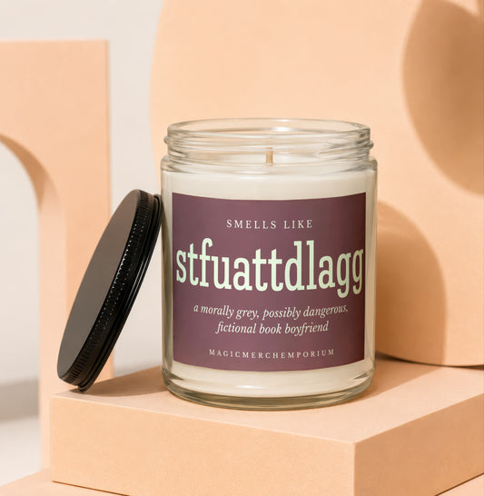 Glass candle with "stfuattdlagg" and "fictional book boyfriend" text.