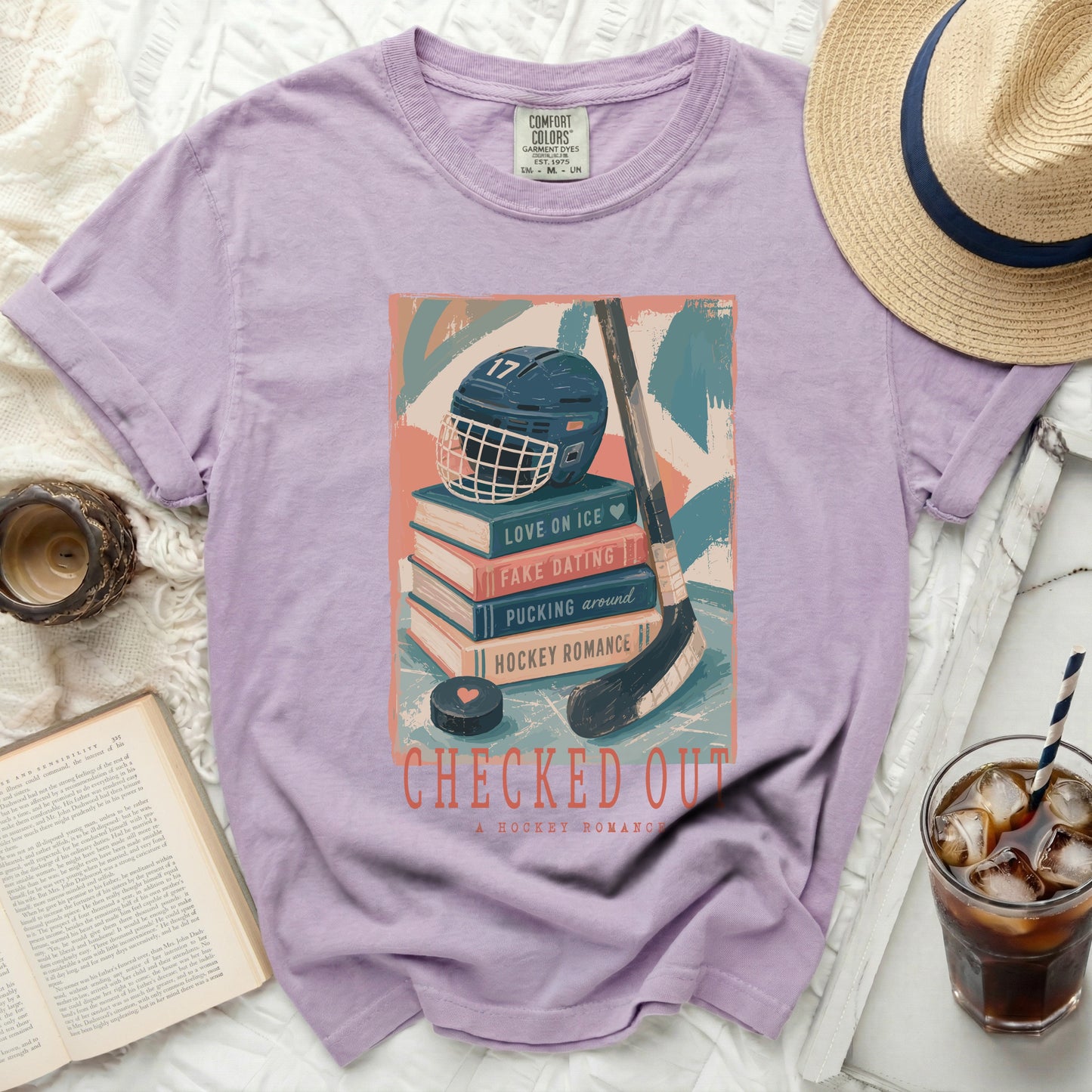 Graphic tee with hockey helmet, books, and "Checked Out" title.