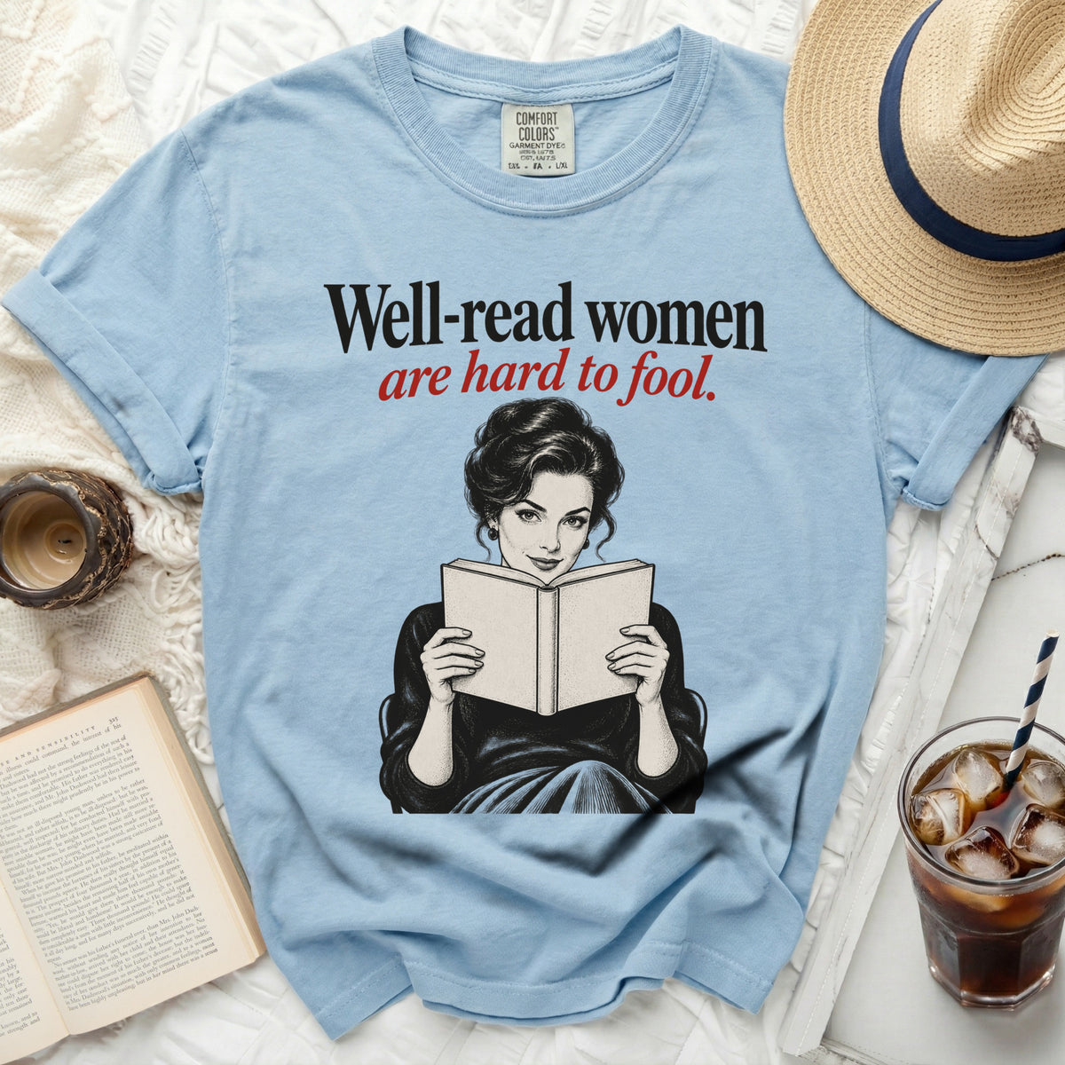 Light blue t-shirt with "Well-read women are hard to fool" text and graphic.