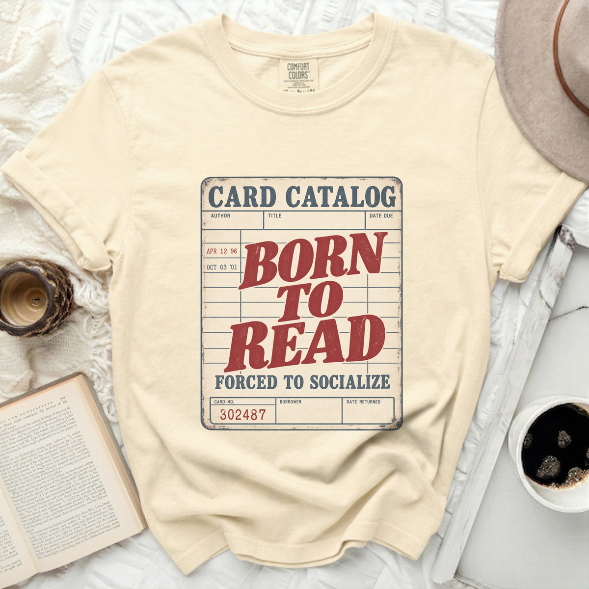 Cream t-shirt with "Born to Read Forced to Socialize" card catalog graphic.