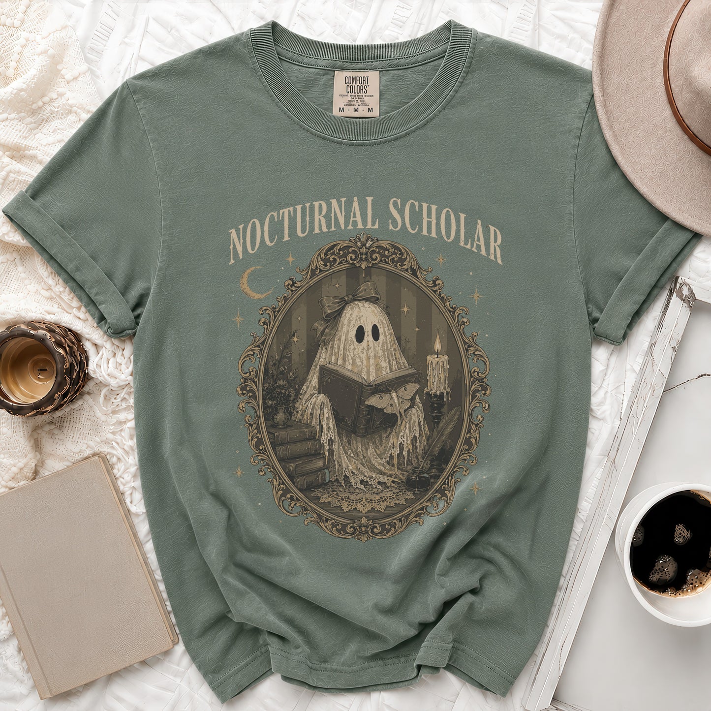 Green t-shirt with "Nocturnal Scholar" text and a ghost reading a book design.