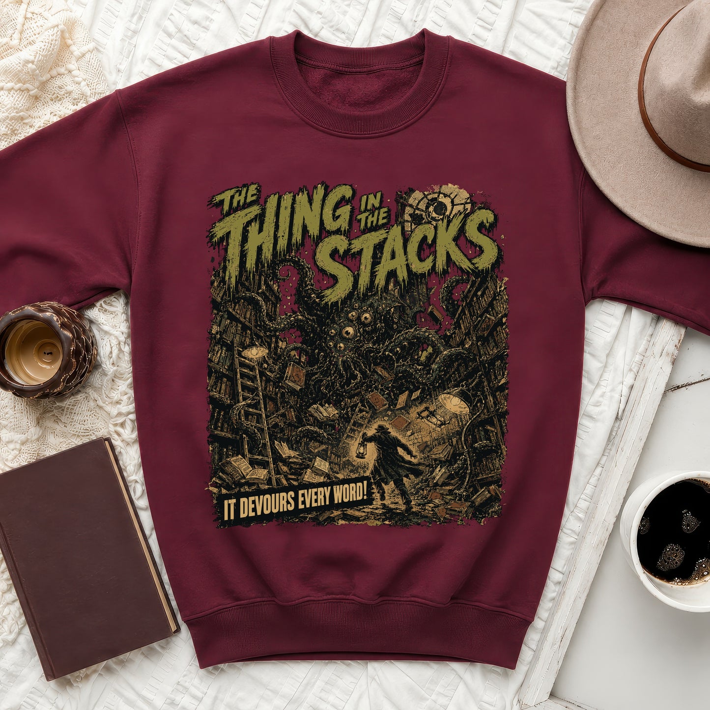 Maroon sweatshirt with "The Thing in the Stacks" text and a monster illustration.