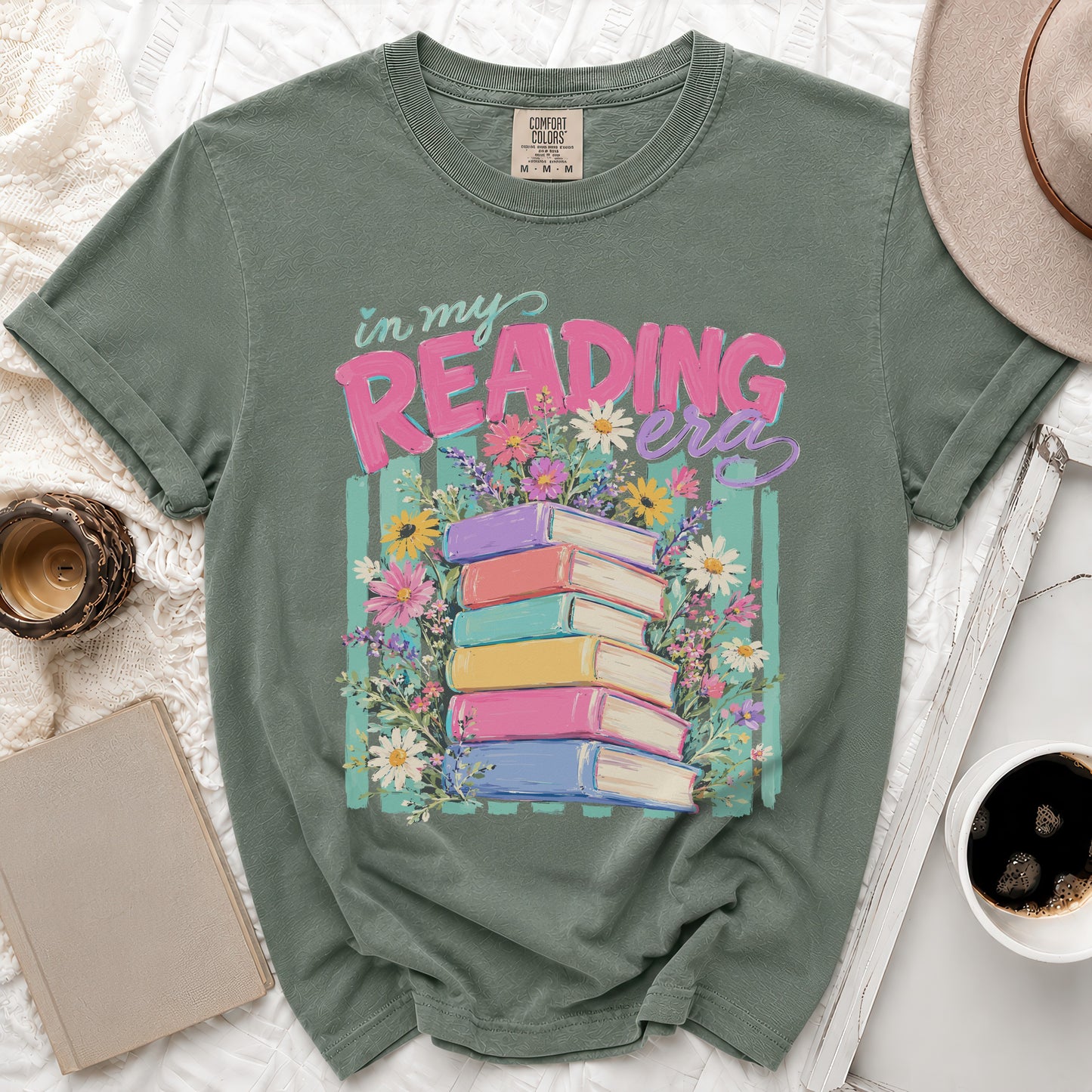 Green t-shirt with "In My Reading Era" text and stack of colorful books.