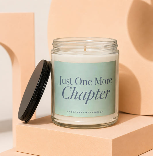 Glass candle with label reading "Just One More Chapter" next to lid.