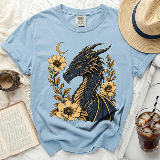 Light blue t-shirt with dark dragon and yellow flowers graphic.