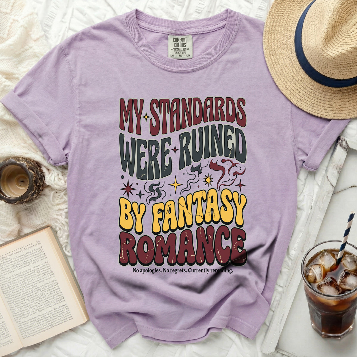 Lilac t-shirt with "MY STANDARDS WERE RUINED BY FANTASY ROMANCE" text.