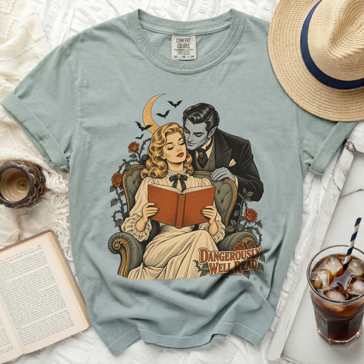 Vampire couple reading with bats and moon. "DANGEROUSLY WELL READ" text.