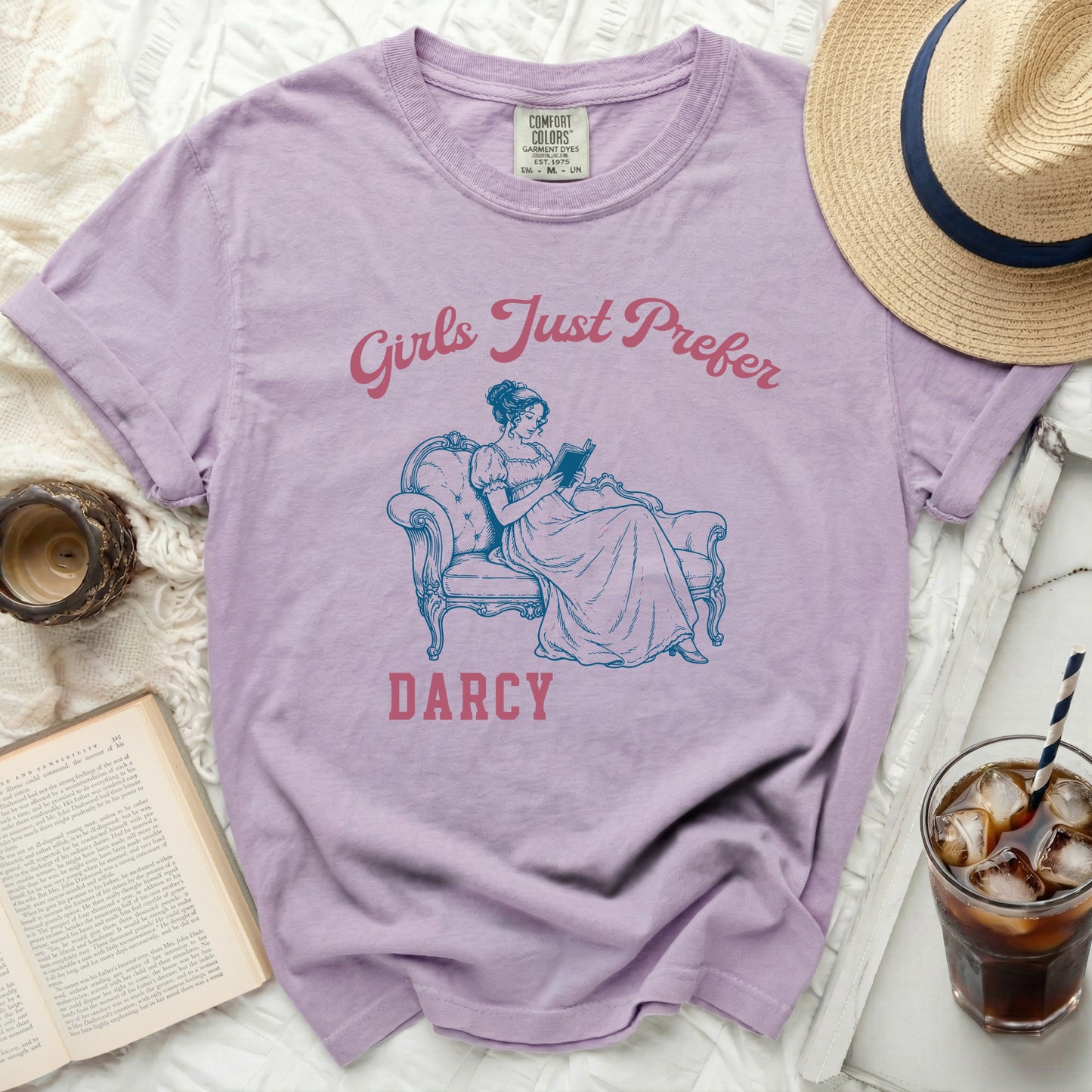 Purple t-shirt with "Girls Just Prefer Darcy" and a woman reading.