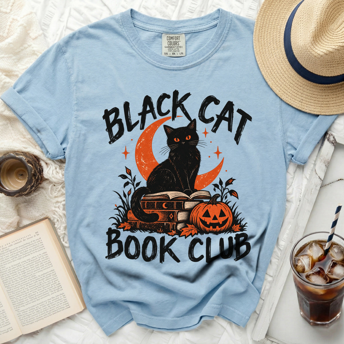 Light blue t-shirt with black cat, moon, pumpkin, and "Black Cat Book Club" text.