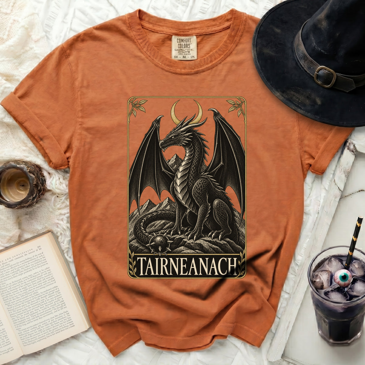 Orange t-shirt with a black dragon graphic and text "TAIRNEANACH"