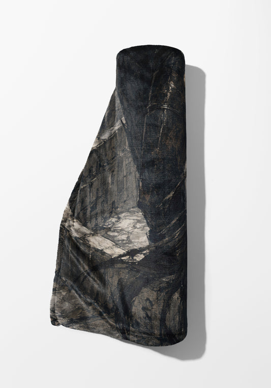 Rolled blanket with dark camouflage pattern against a white background.