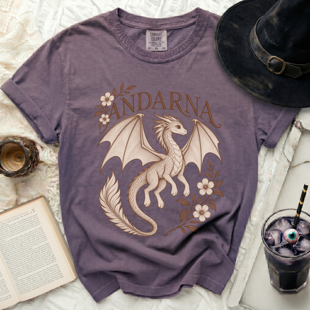 Purple crewneck t-shirt featuring a vintage dragon illustration and the text Andarna surrounded by flowers.