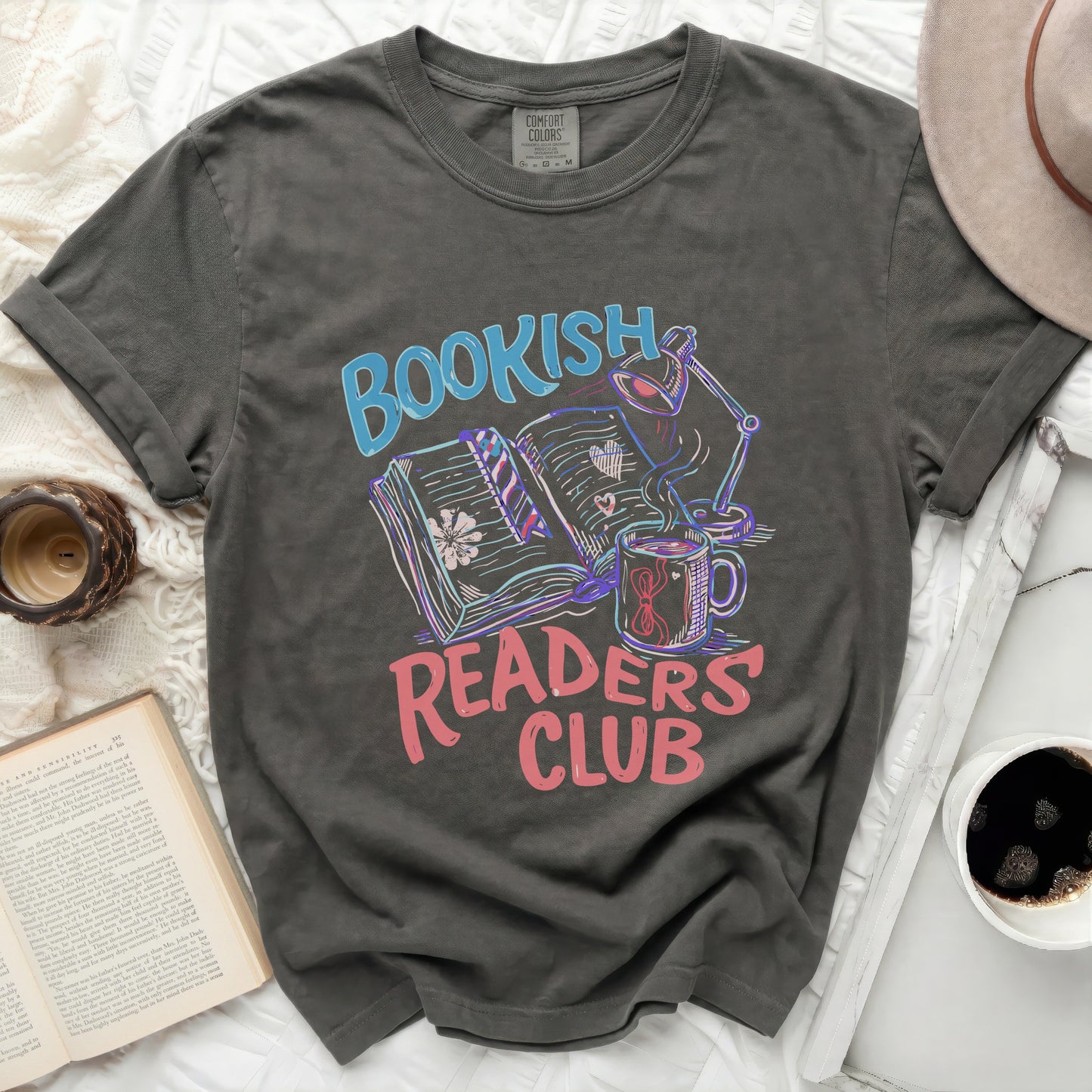 Bookish Readers Club graphic on dark gray t-shirt with books, lamp, and mug.