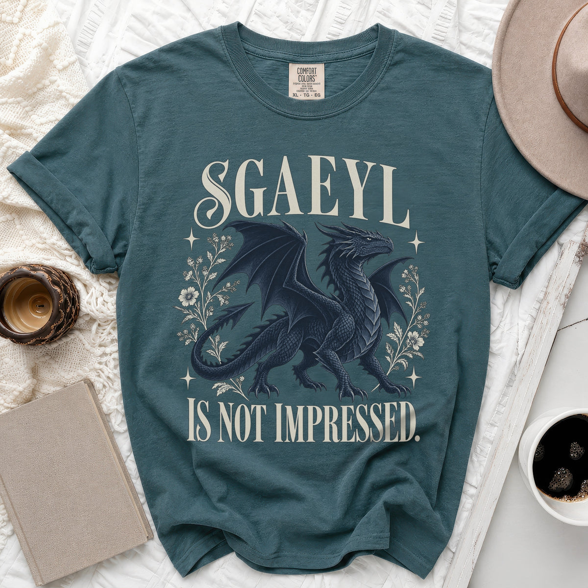 Teal t-shirt with "SGAEYL IS NOT IMPRESSED" text and a black dragon graphic.