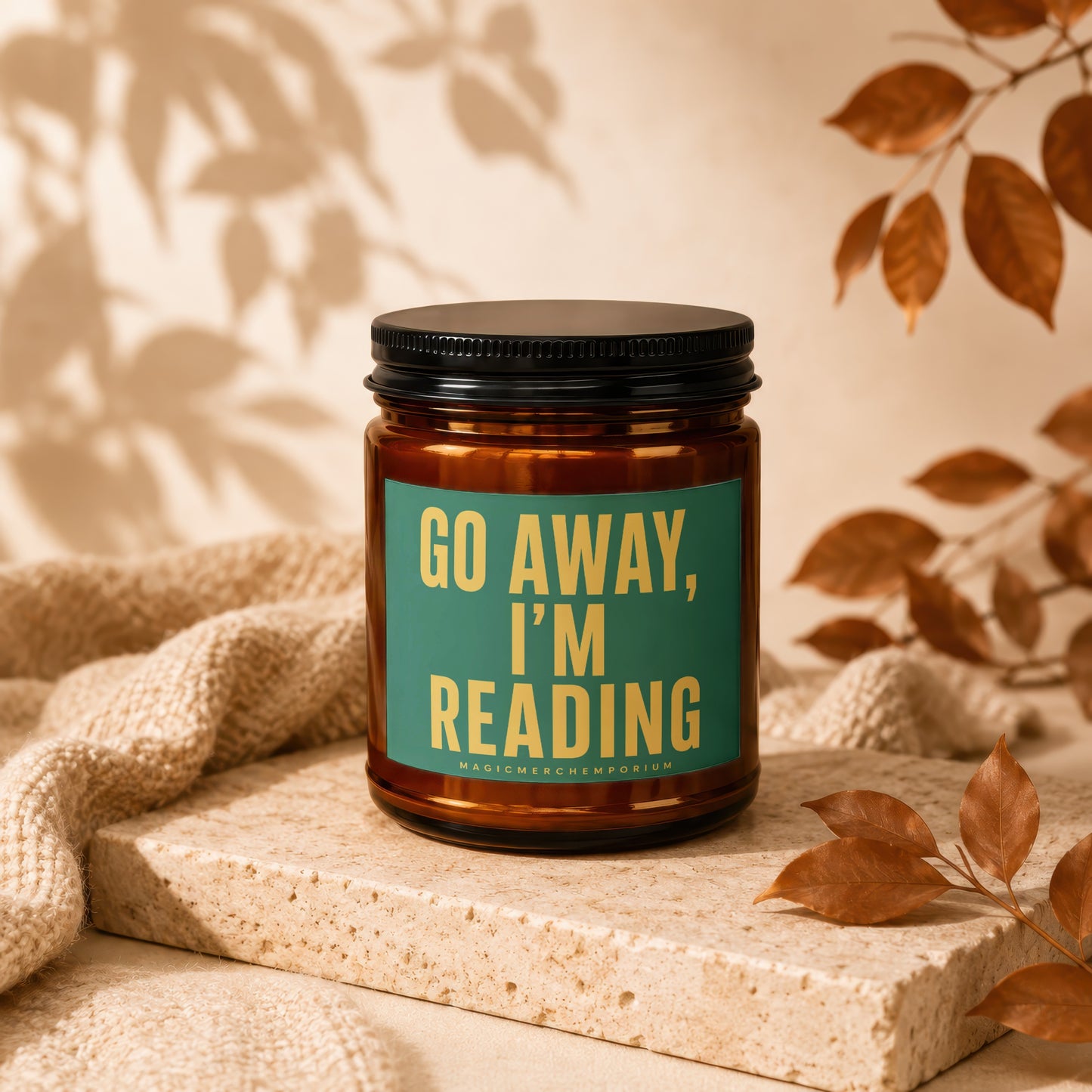 Amber jar candle with "GO AWAY, I'M READING" text on a teal label.