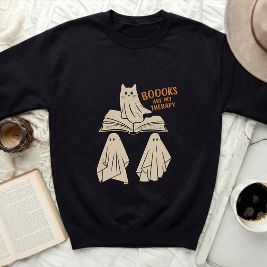 Black sweatshirt with ghosts and "BOOOKS ARE MY THERAPY" text.