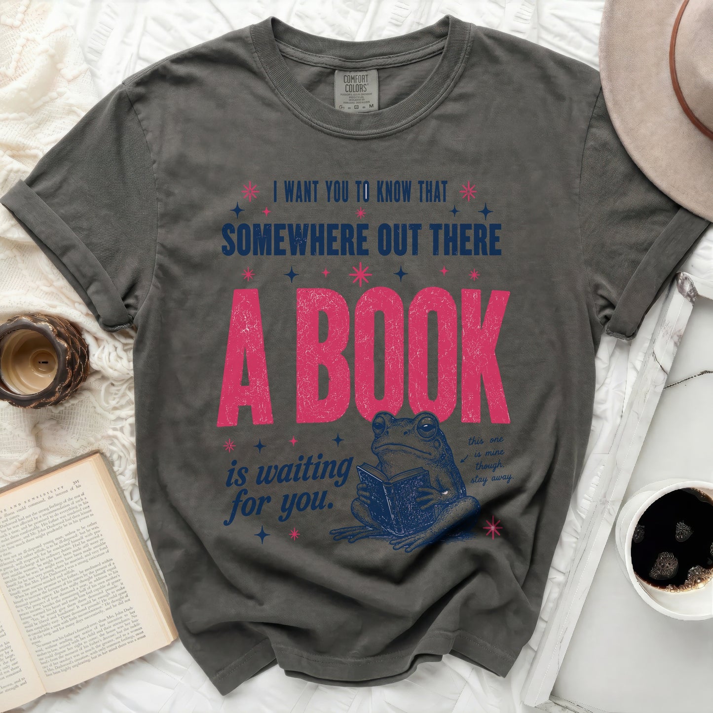 Dark grey t-shirt with frog reading book and inspirational text.