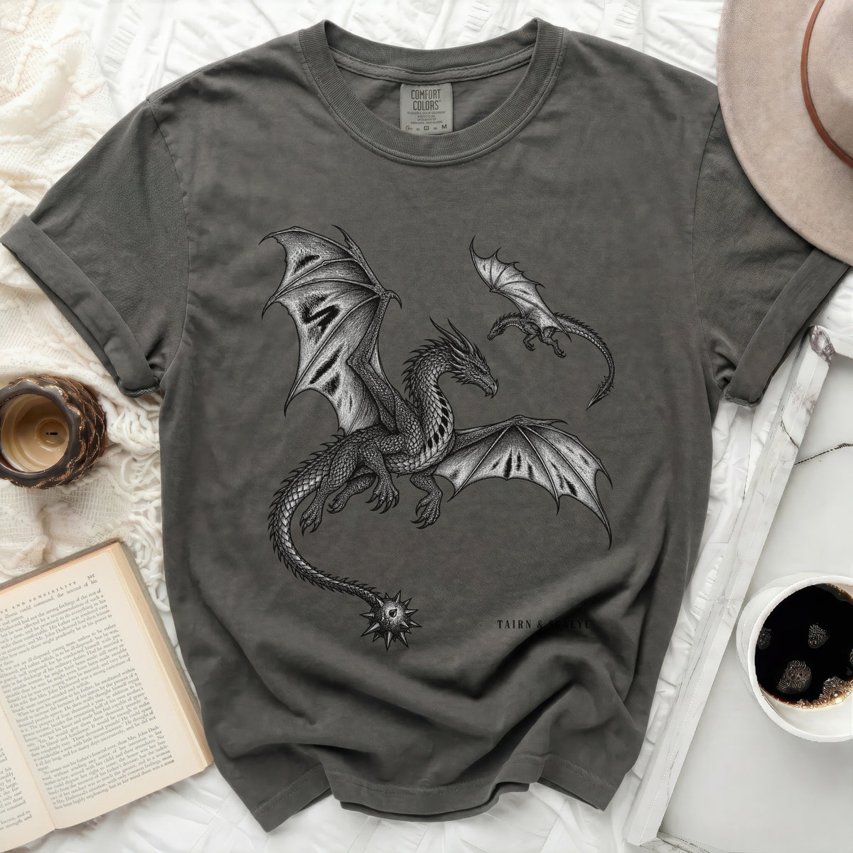 Dark grey t-shirt with a detailed dragon illustration and "TAIRN & SCAEYL" text.