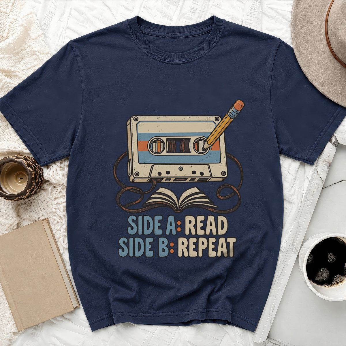 Navy t-shirt with cassette, pencil, and book graphic reading "Side A: Read, Side B: Repeat".