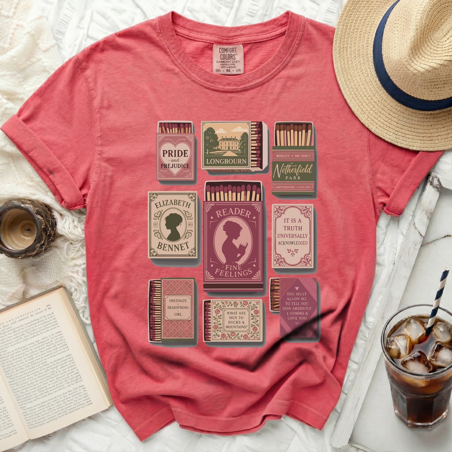 Pink t-shirt with book-themed matchbox designs: Pride and Prejudice, Longbourn, Netherfield.