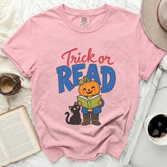Pink t-shirt with "Trick or READ" text, a pumpkin reading a book, and a black cat.