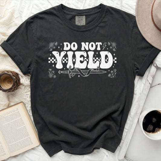 Dark t-shirt with white "DO NOT YIELD" text and sword graphic.