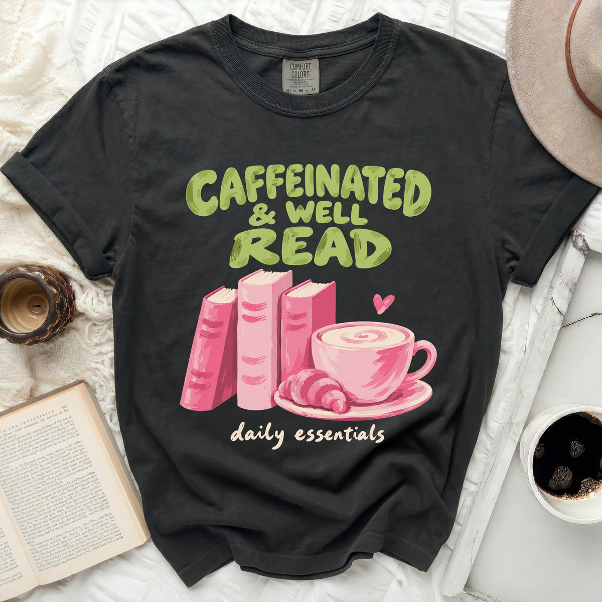 Black t-shirt with "Caffeinated & Well Read daily essentials" text and book graphics.