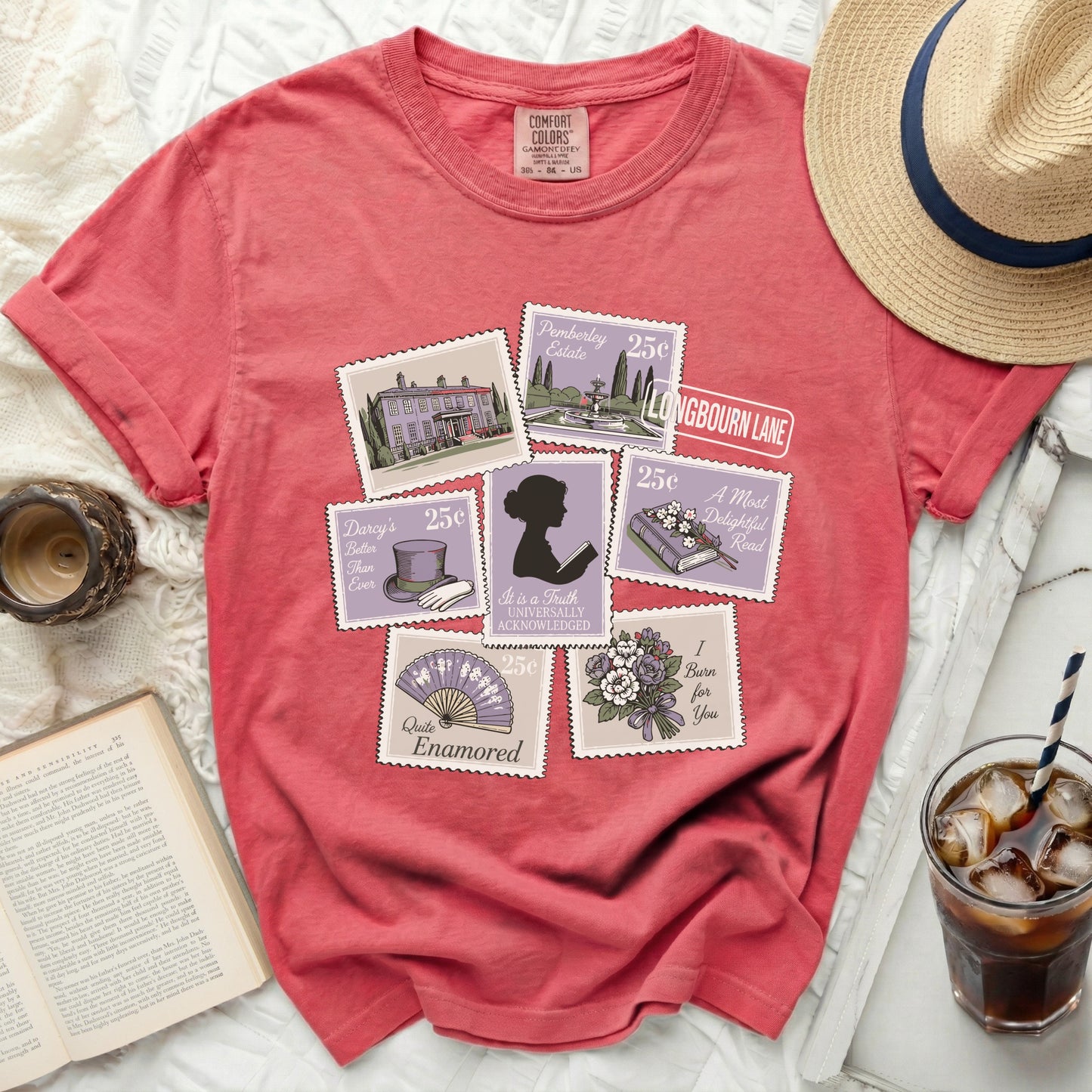 Salmon colored t-shirt with postage stamp designs featuring literary references.