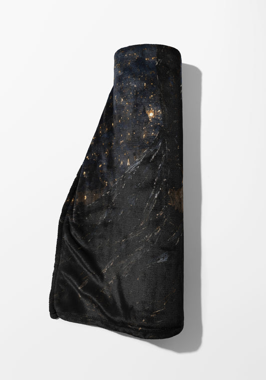 Rolled black throw blanket with a dark, speckled pattern resembling a starry night.