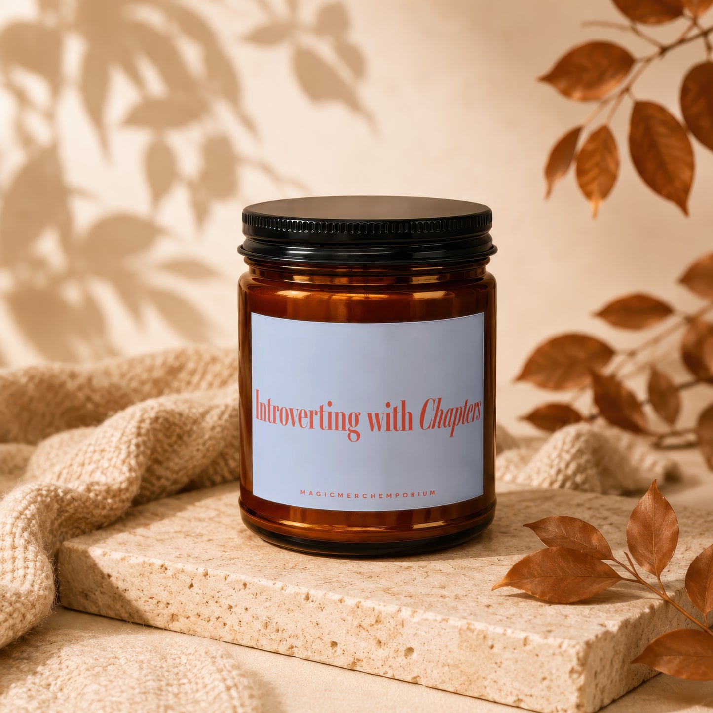 Amber jar candle with white label reading "Introverting with Chapters".