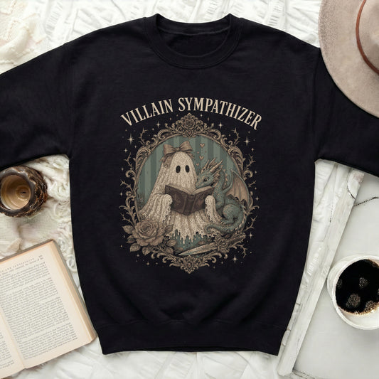 Black sweatshirt with a framed print of a ghost reading a book to a dragon.