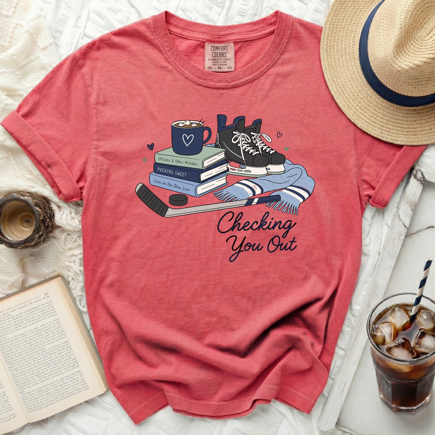 Coral t-shirt with hockey skates, puck, stick, and text "Checking You Out".