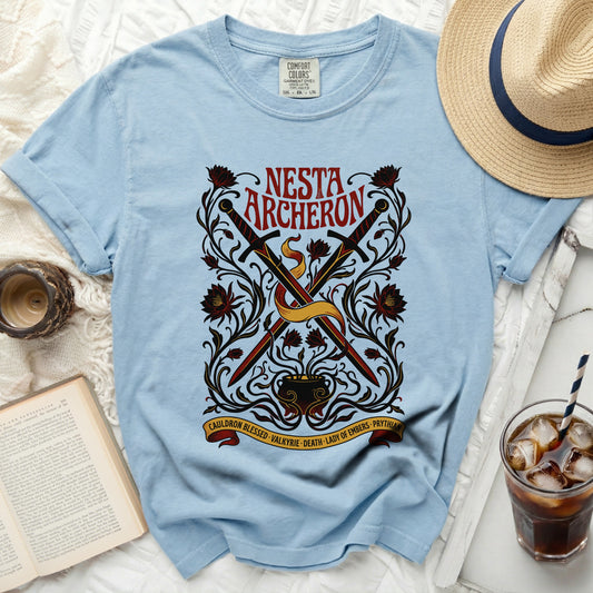 Light blue t-shirt with "Nesta Archeron" and crossed swords design.