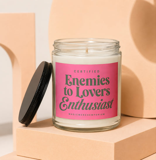 Glass jar candle with pink label reading "Certified Enemies to Lovers Enthusiast"