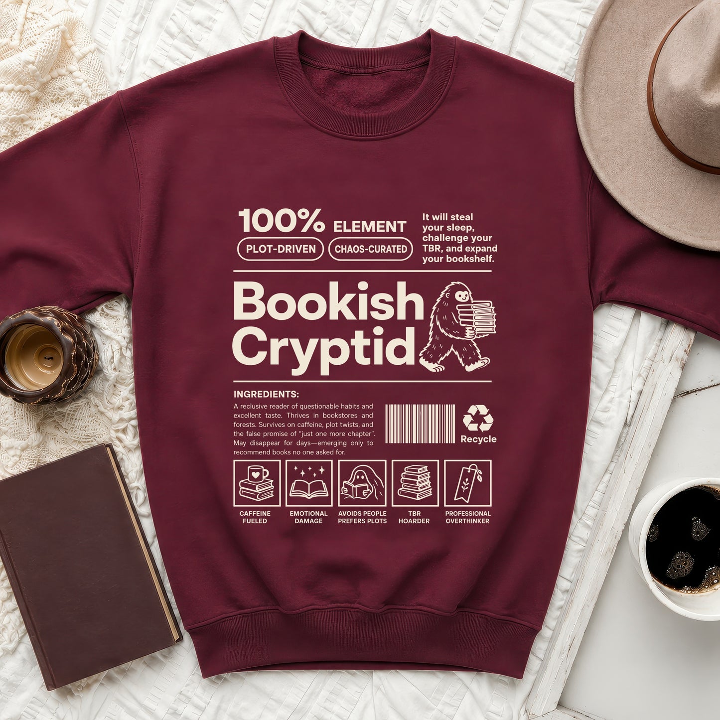 Maroon sweatshirt with "Bookish Cryptid" design and book-themed ingredients.