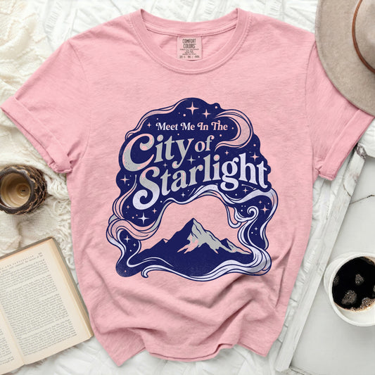 Pink t-shirt with "Meet Me In The City of Starlight" graphic.
