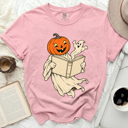 Pumpkin ghost reading a book and a small ghost looking on.