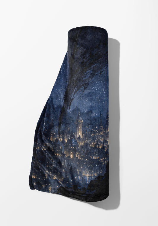 Rolled dark blue blanket with a starry night sky and illuminated cityscape pattern.