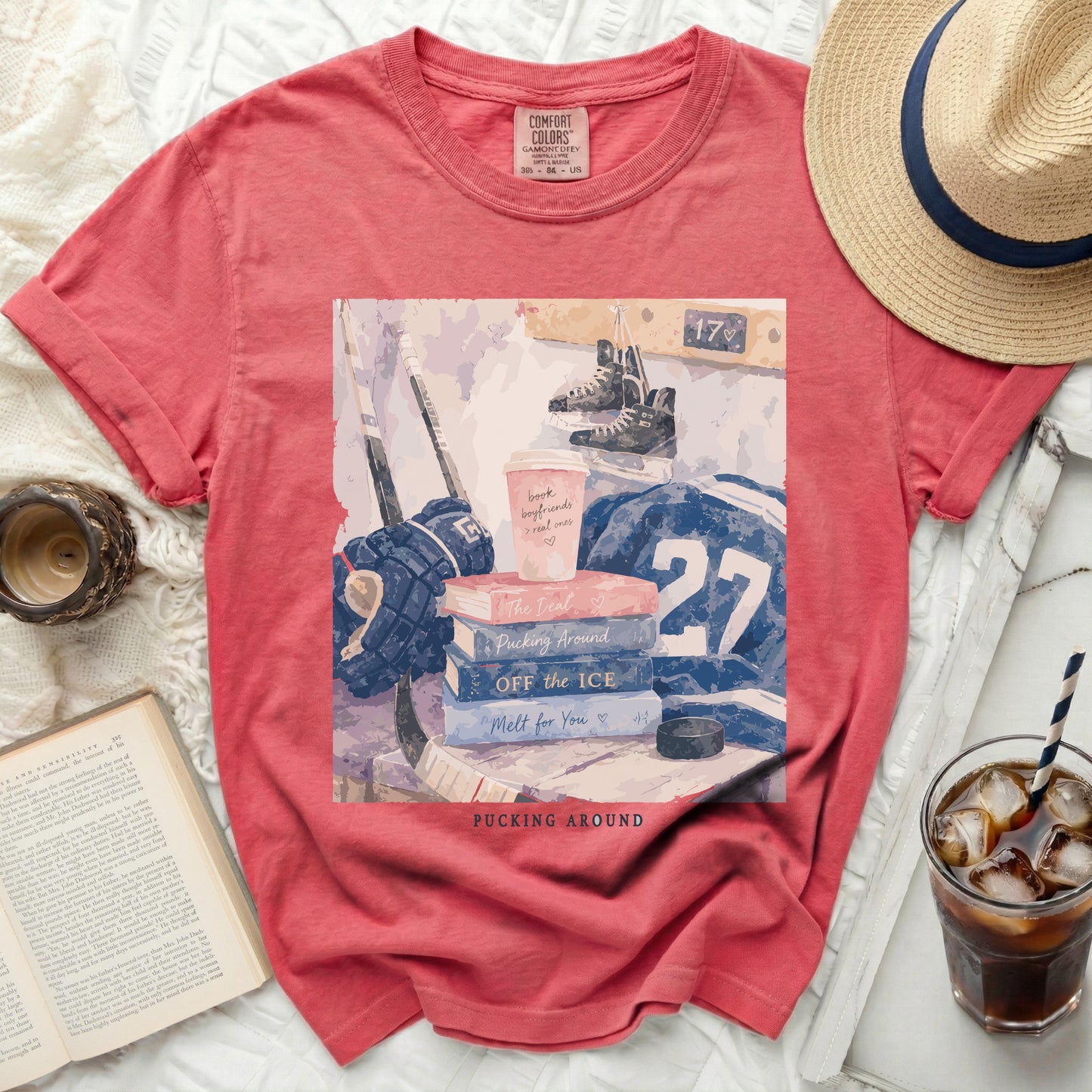 Comfort Colors shirt with hockey, books, and coffee cup graphic.
