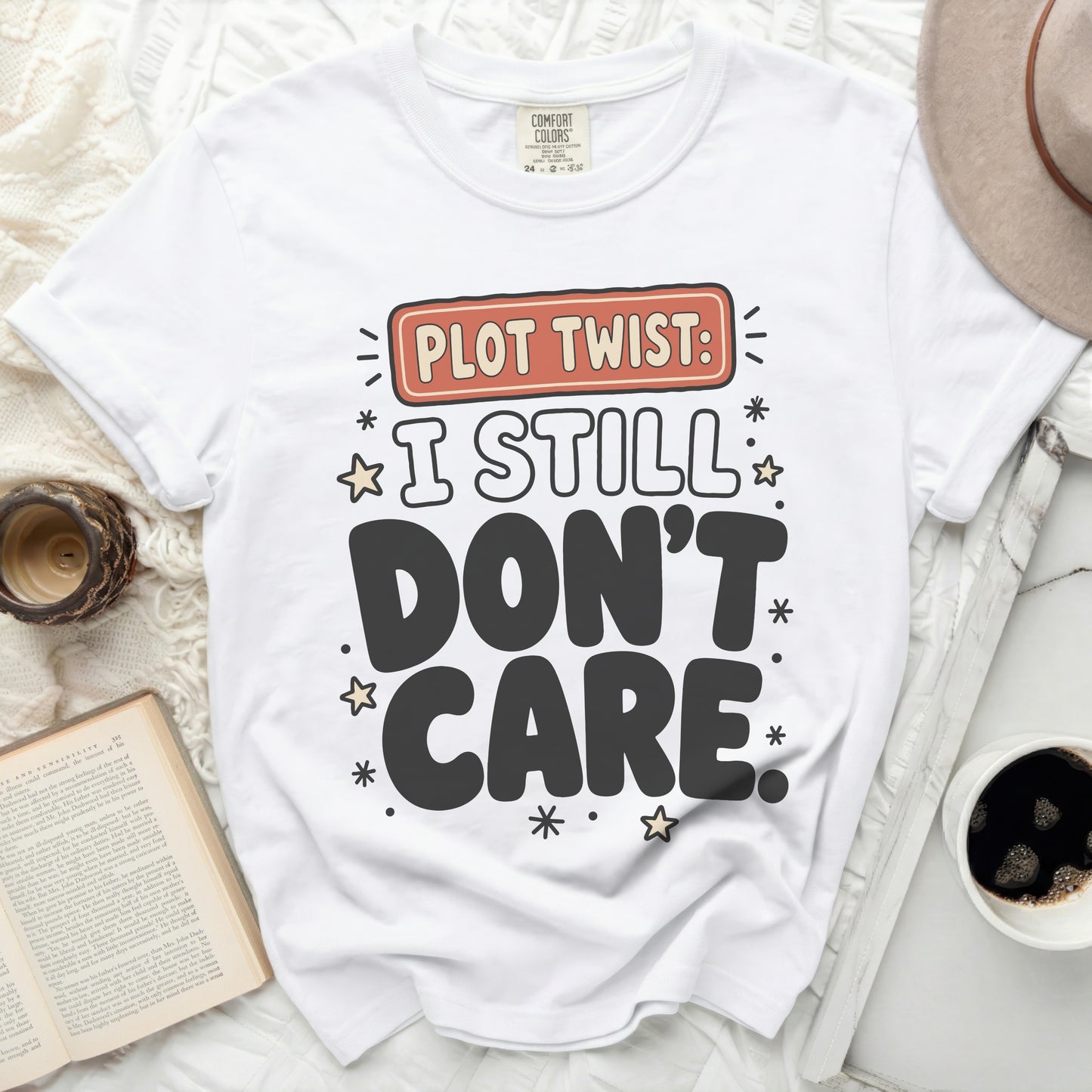 White t-shirt with "Plot Twist: I Still Don't Care" text and stars.