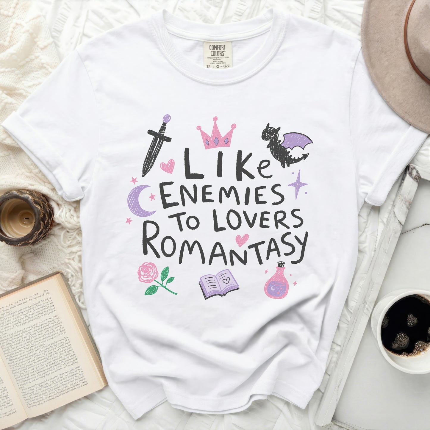 White t-shirt with "Like Enemies To Lovers Romantasy" doodle graphic.