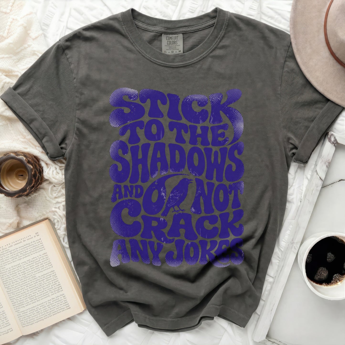 Dark gray t-shirt with purple text "Stick to the shadows and do not crack any jokes".