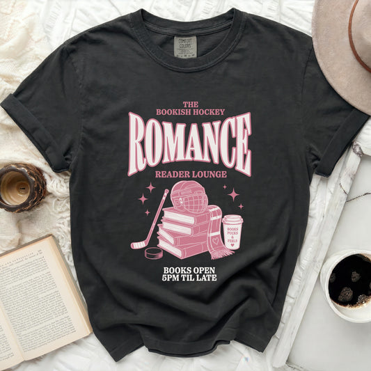 Bookish Hockey Reader Lounge graphic tee with books, pucks, and cup.